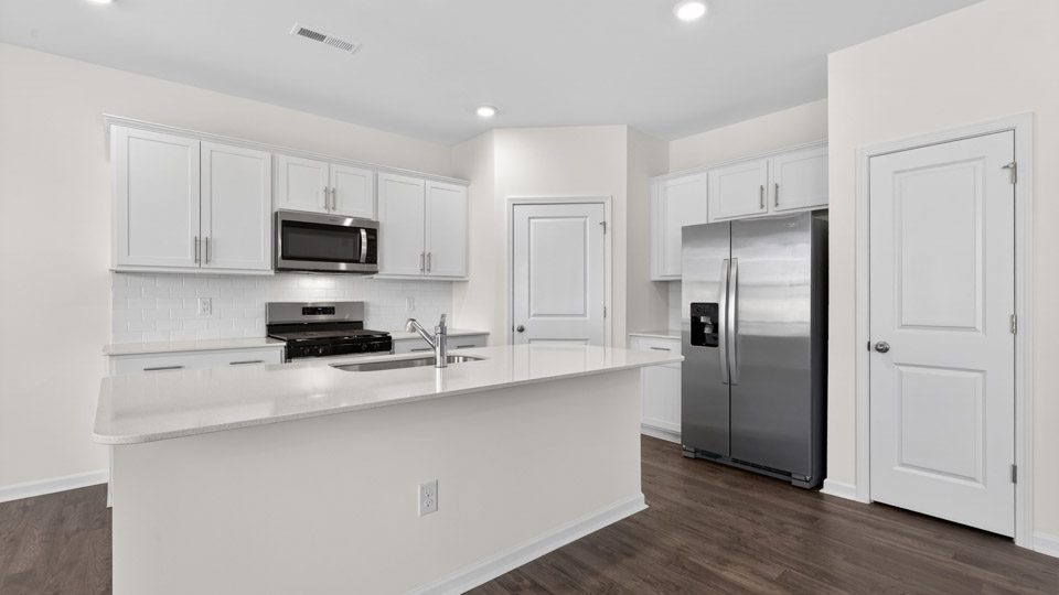 Kitchen with white cabinets and stainless steel appliances.