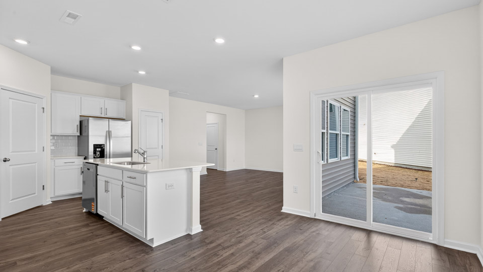 Kitcen with sliding glass back door leading to back patio