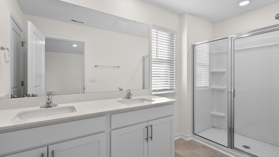 Primary bathroom with double sink and walk-in shower