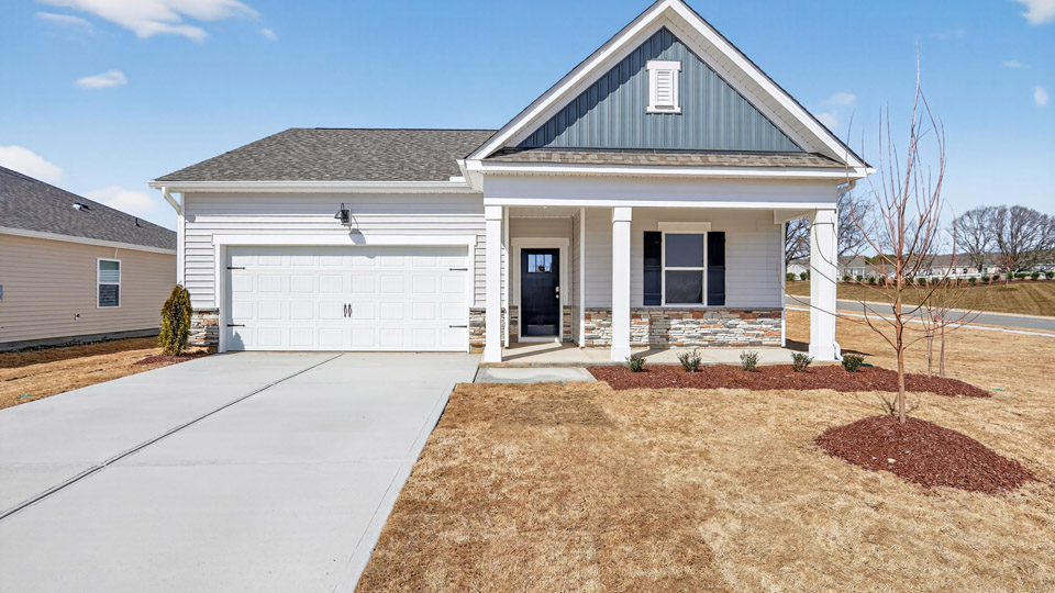 Single story home with white/Blue siding and a two-car garage.