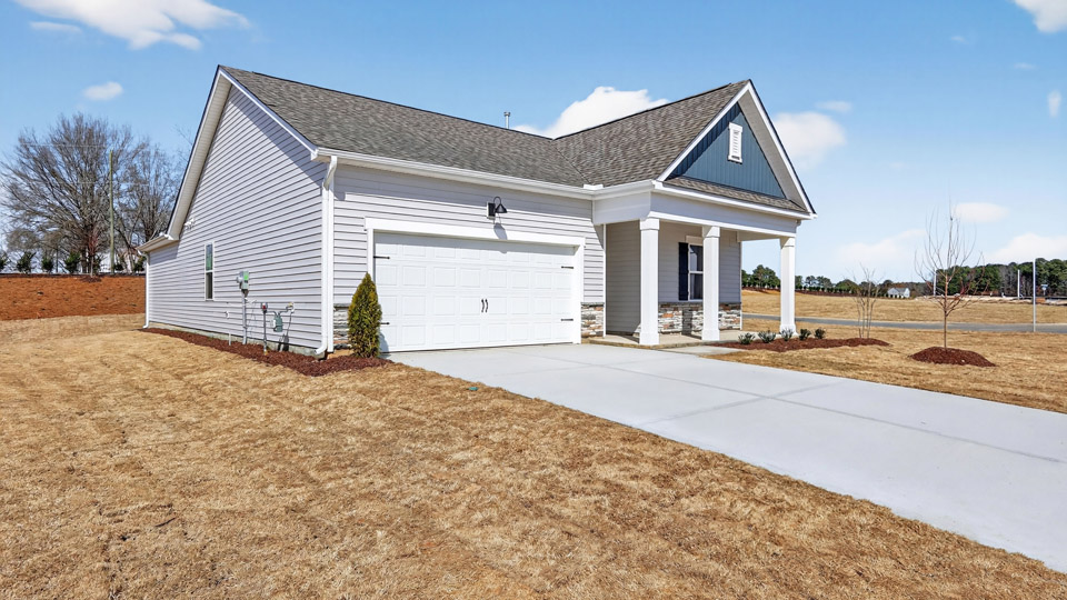 Single story home with white/Blue siding and a two-car garage.