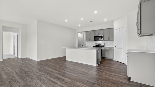 kitchen with gray cabinets island and quartz countertops