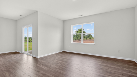 living room off of breakfast area with revwood flooring