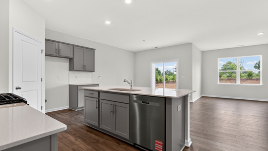 kitchen with gray cabinets island and quartz countertops
