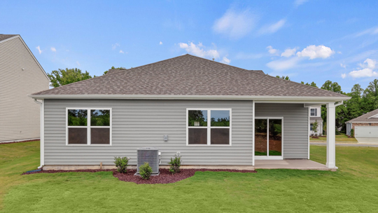 back of home with covered concrete patio