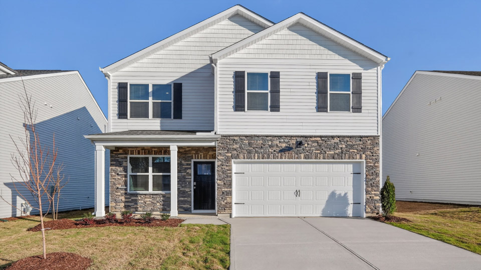 Two story home with white colored siding with a two car garage