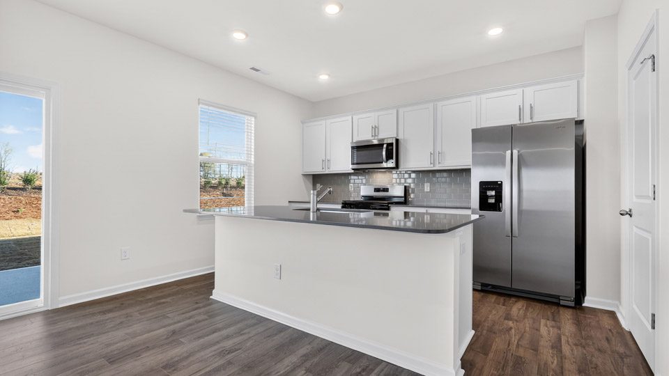 Kitchen with white cabinets and stainless steel appliances.