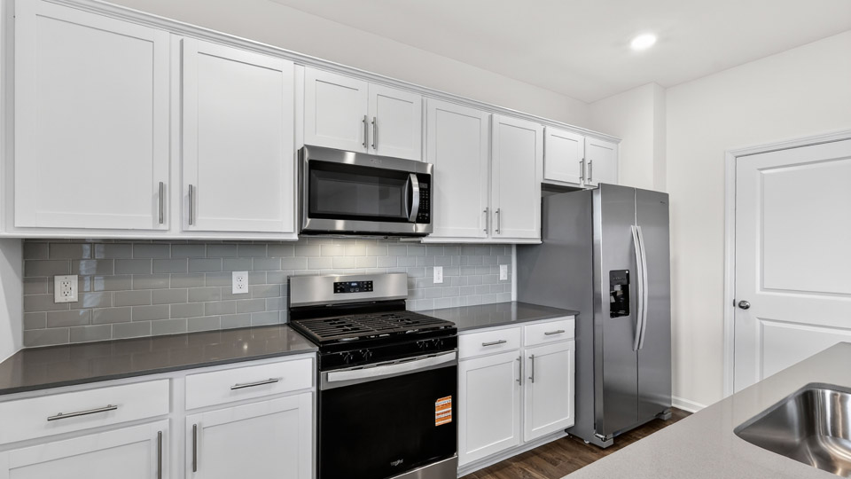 Kitchen with white cabinets and stainless steel appliances.