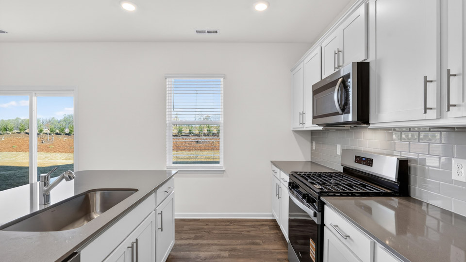Kitchen with white cabinets and stainless steel appliances.