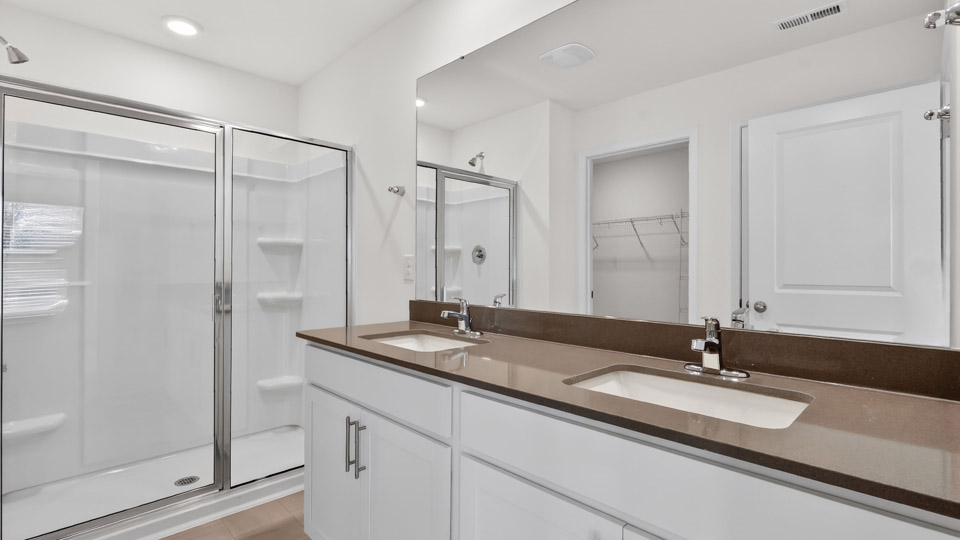Primary bathroom with double sink and walk-in shower