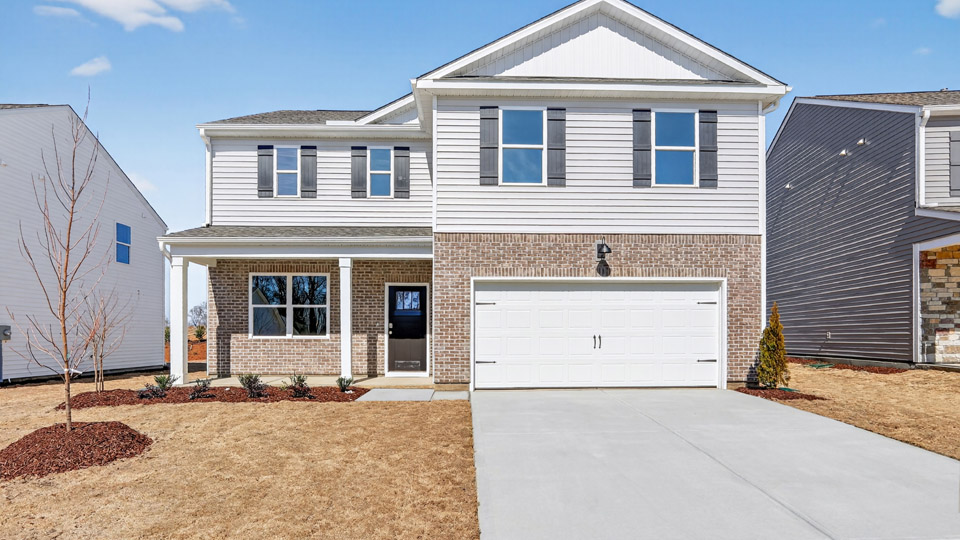 Two story home with gray colored siding with a two car garage