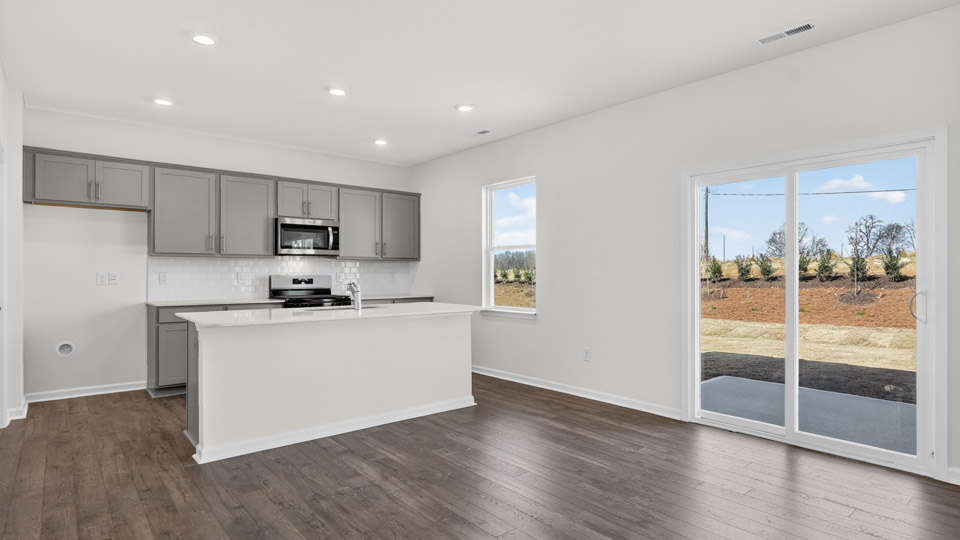 Kitchen with gray cabinets and stainless steel appliances.