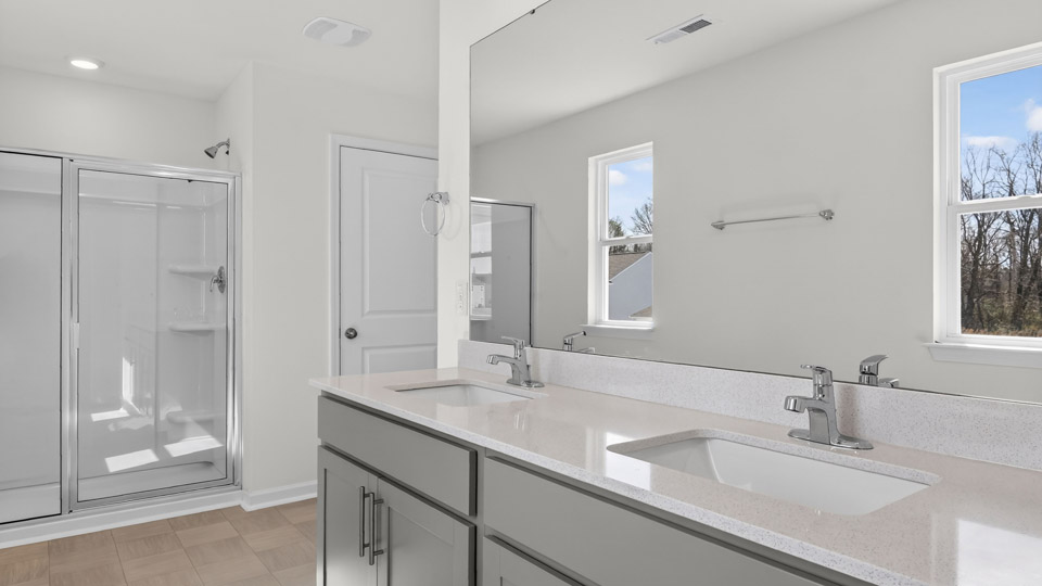 Primary bathroom with double sink and walk-in shower