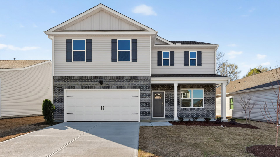 Two story home with white colored siding with a two car garage