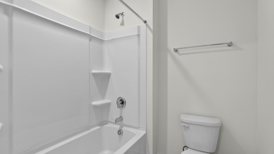secondary bathroom with shower tub combo and dual vanity sink