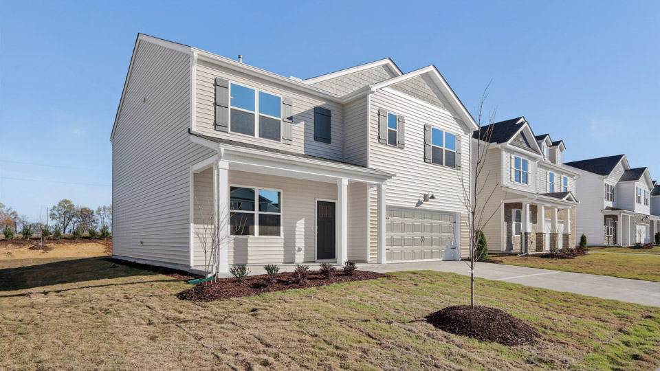 Two story home with white colored siding with a two car garage