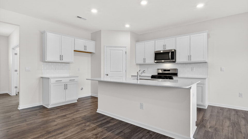 Kitchen with white cabinets and stainless steel appliances.