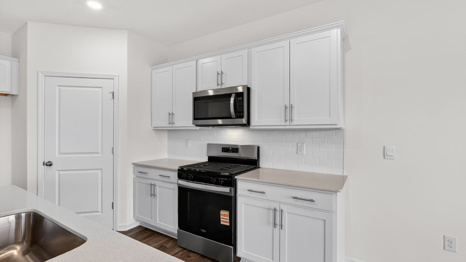Kitchen with white cabinets and stainless steel appliances.