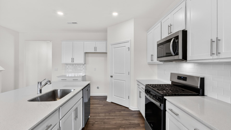 Kitchen with white cabinets and stainless steel appliances.