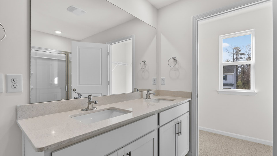 Primary bathroom with double sink and walk-in shower