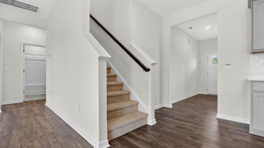 bottom of staircase with closed railing