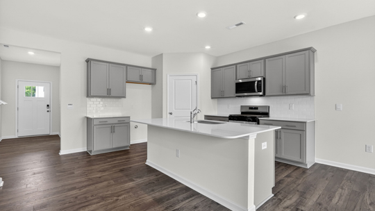 kitchen with island quartz countertops and gray cabinets