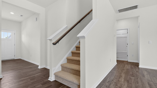 bottom of stairs with closed railing