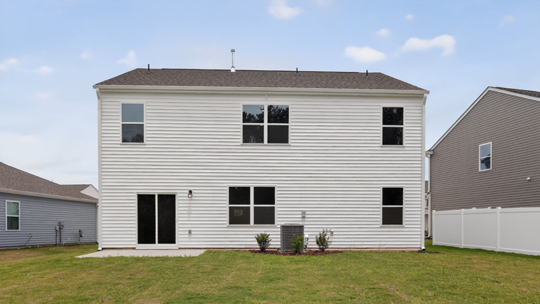back of home with concrete patio