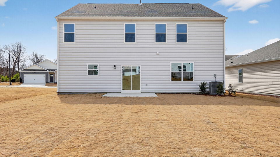 Back patio and view of back of the home