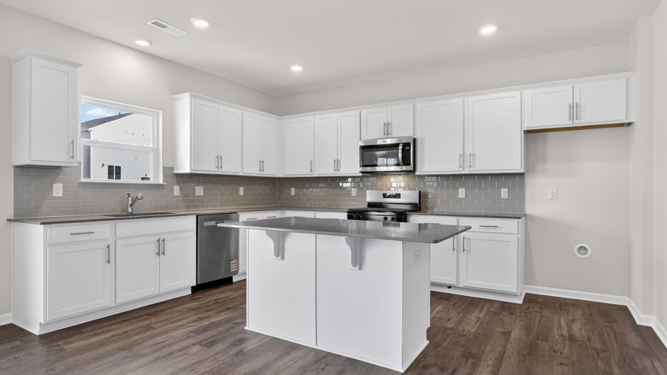 Kitchen with white cabinets and stainless steel appliances.