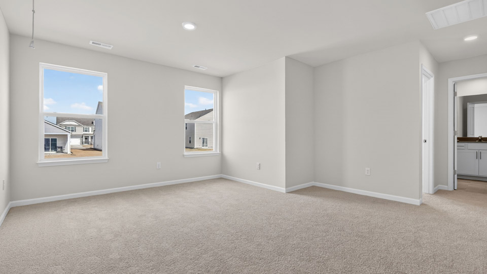 Upstairs loft area with carpet and windows