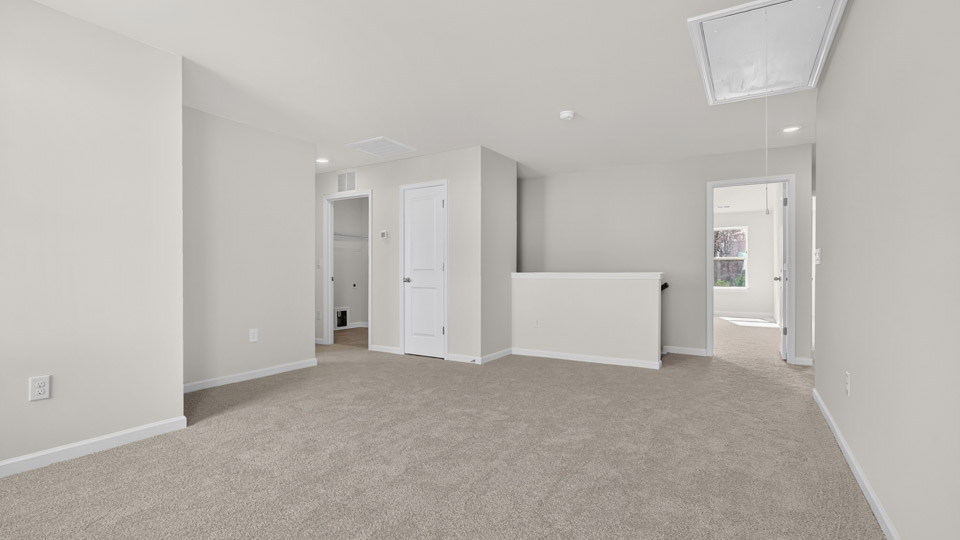 Upstairs loft area with carpet & windows