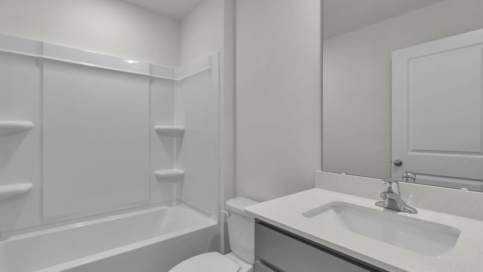 secondary bathroom with shower tub combo and single vanity sink