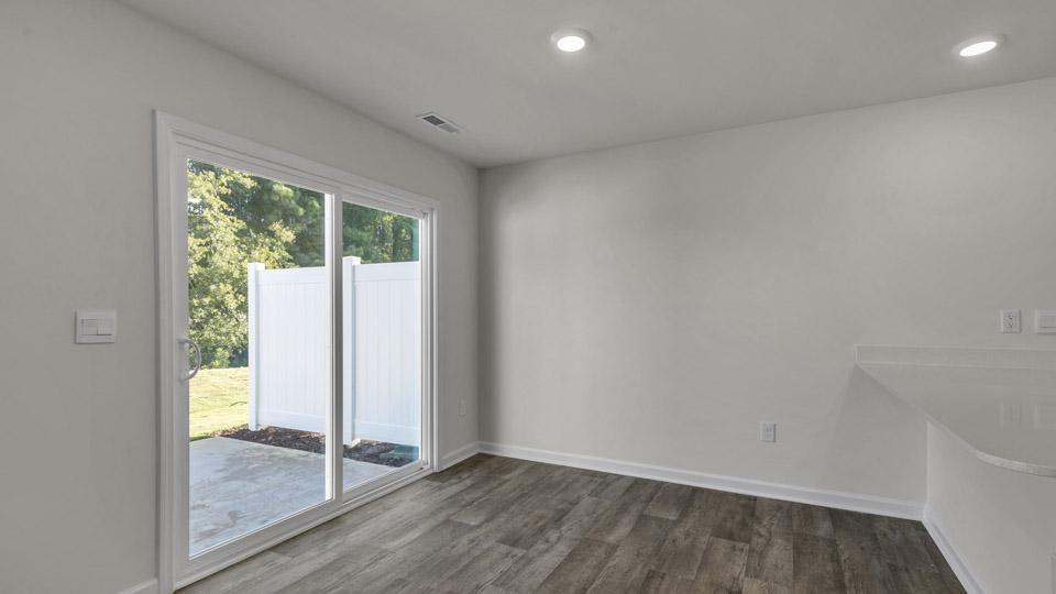 open concept dining space with door to patio