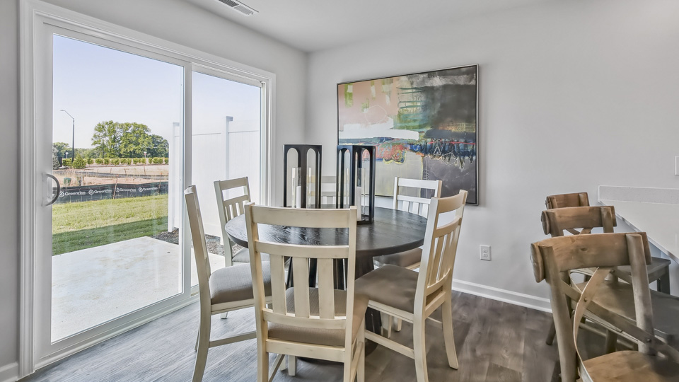 open concept dining space with door to patio
