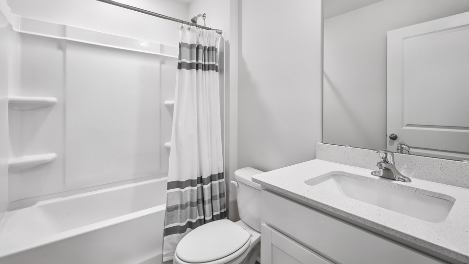 secondary bathroom with shower tub combo and single vanity sink