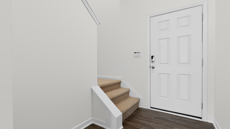foyer entryway with carpeted staircase