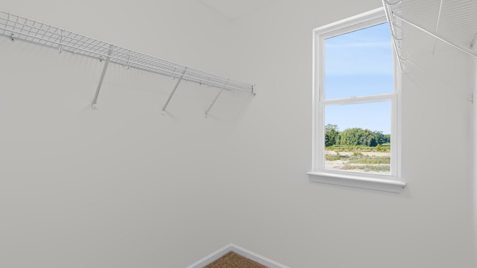 walkin closet with wire shelving and window for natural lighitng