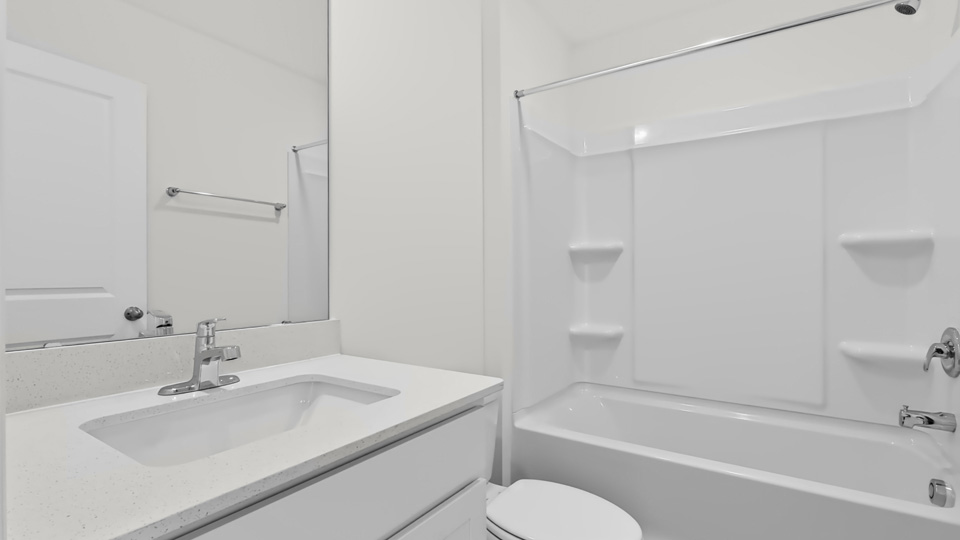 bathroom with tub shower combo and quartz countertops