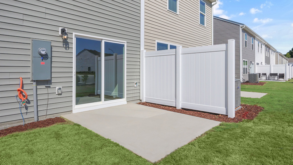 back concrete patio with partition wall