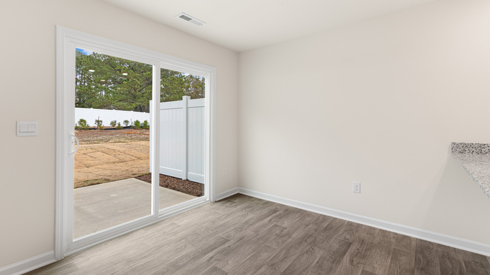 open concept dining space with door to patio