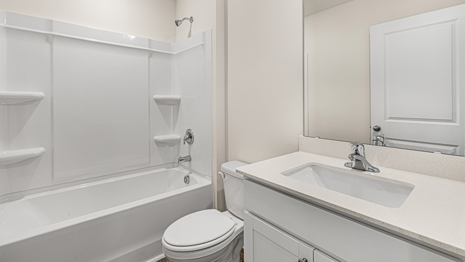 secondary bathroom with shower tub combo and single vanity sink