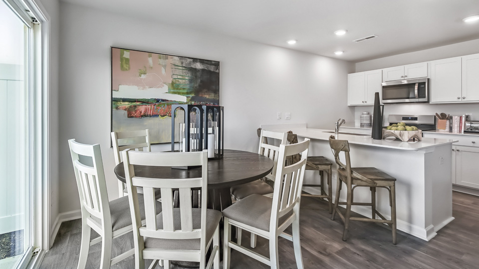 kitchen with quartz counters, kitchen island, pantry, stainless steel appliances