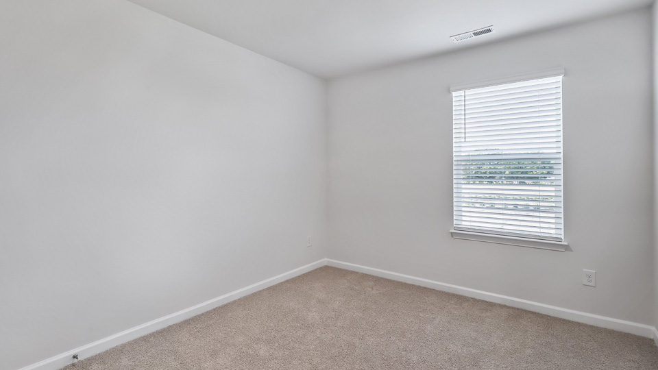 additional bedroom with window, carpeting, closet