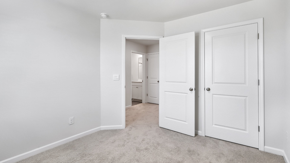 additional bedroom with window, carpeting, closet