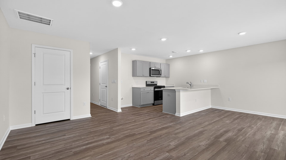 Open-concept living room leading to kitchen