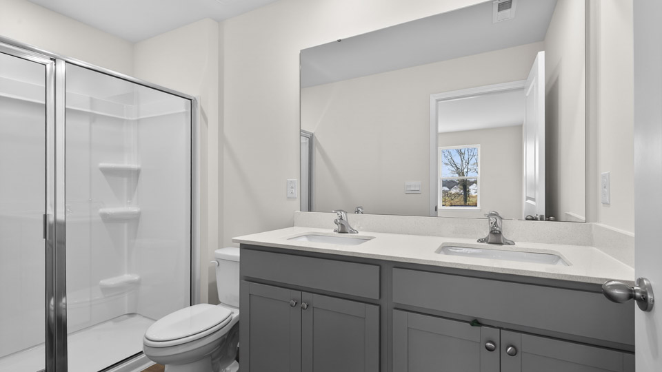 Primary bathroom with walk-in shower and double sink