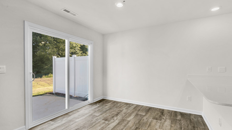 open concept dining space with door to patio