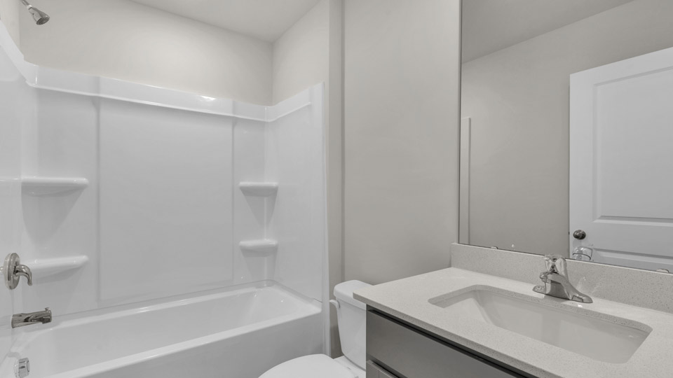 secondary bathroom with shower tub combo and single vanity sink