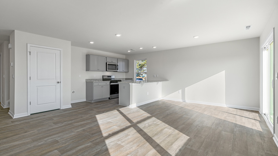 kitchen with quartz counters, kitchen island, pantry, stainless steel appliances